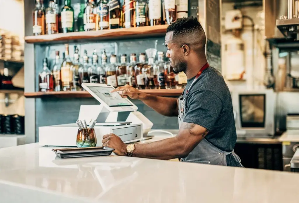 Man using point of sale systems for restaurants and bars from Piggy Bank Processing