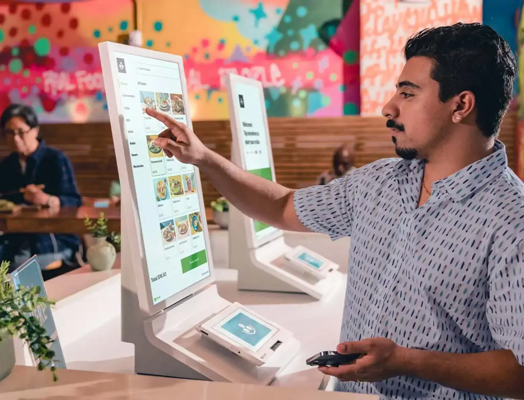 Man using Clover self service kiosk from Piggy Bank Processing