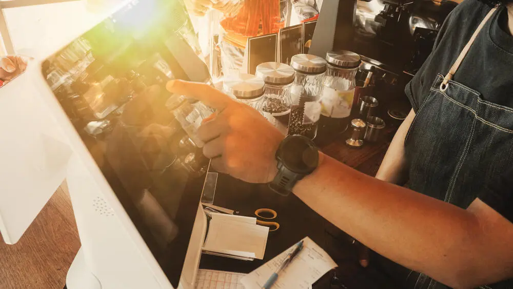 A worker using a POS system