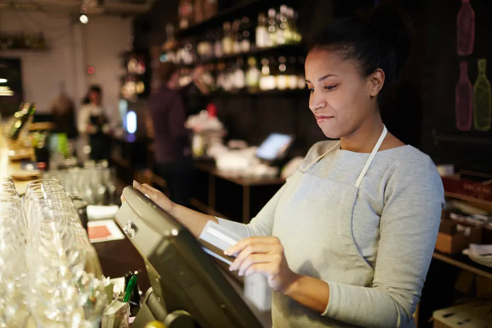 A restaurant worker using a POS system
