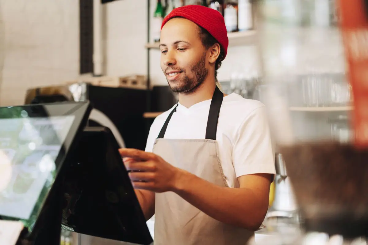 A barista using a POS system